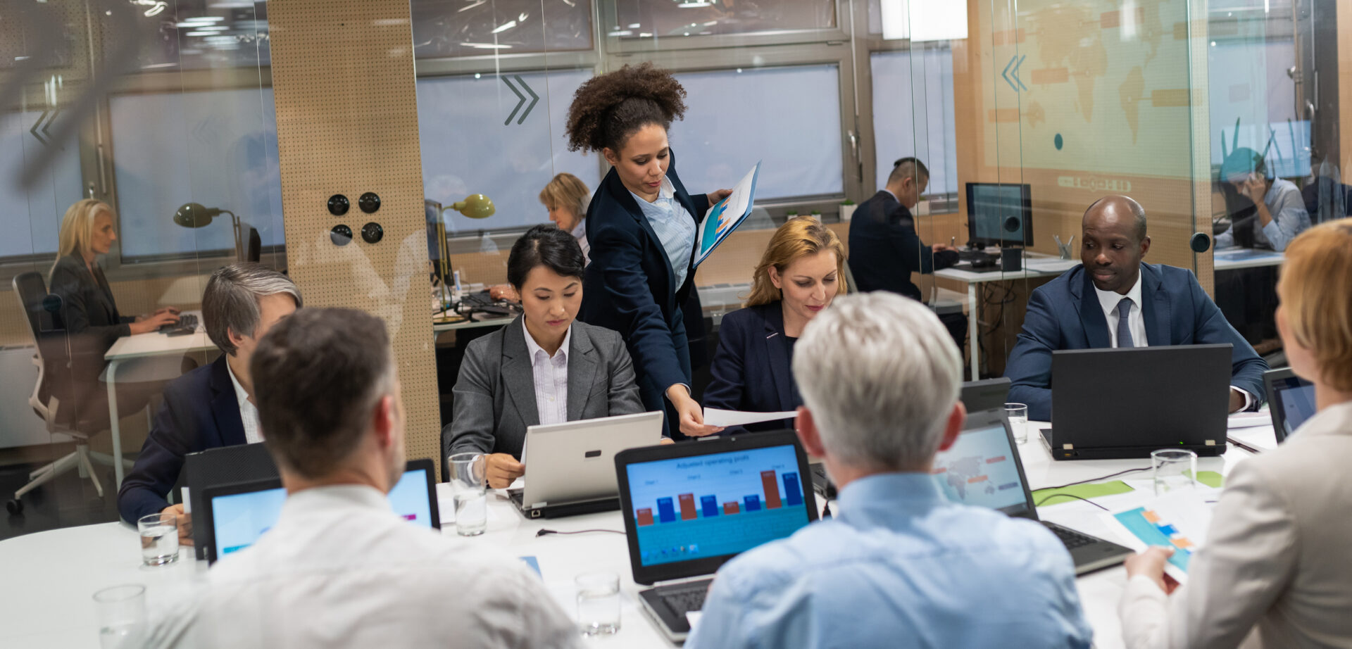 Two business teams sitting in conference room having a meeting